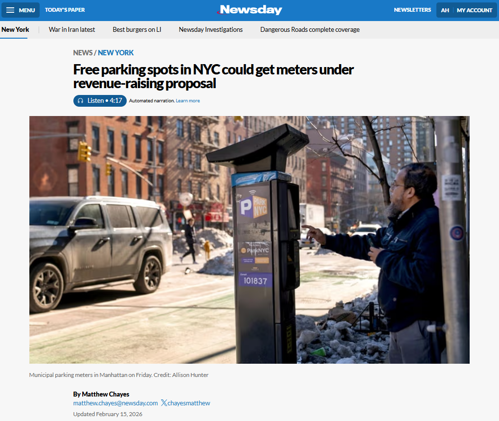 A man uses a ParkNYC municipal parking meter on a Manhattan sidewalk, with a snow-lined street and parked SUV visible behind him.